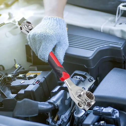 Person using a wrench on a car battery with a focus on mechanical work.