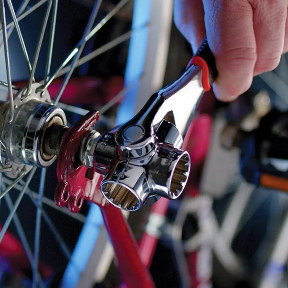 Close-up of a bicycle wheel with a tool being used on a blurred background