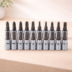 Set of screwdriver bits in a holder on a wooden surface